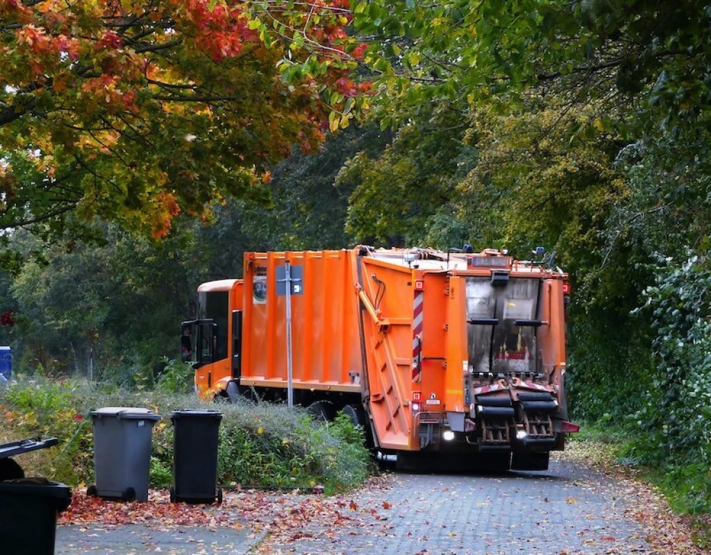 Zippy Dumpster truck delivering container in Irvine, CA