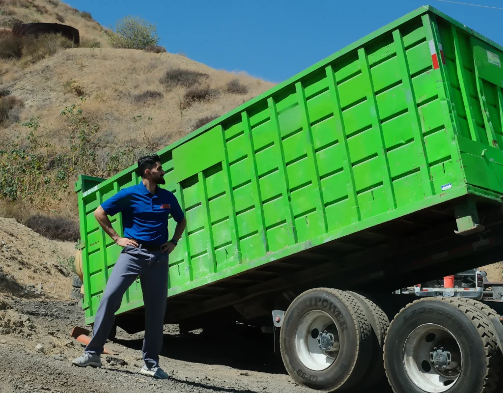 Professional team transporting large dumpster container for convenient waste removal service.